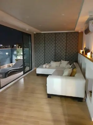 a living room with a white couch and a bed at Penthouse Lux in Belgrade