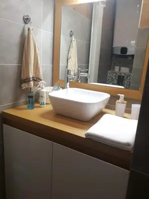 a bathroom with a white sink and a mirror at Penthouse Lux in Belgrade