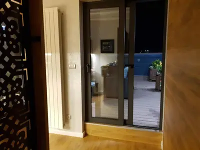 a sliding glass door with a view of a living room at Penthouse Lux in Belgrade