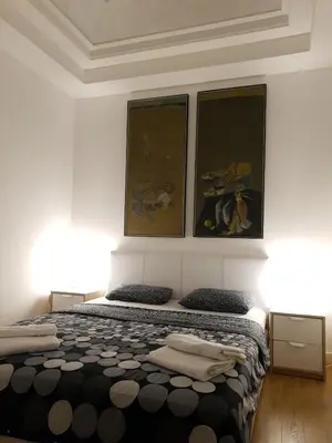 a bedroom with a bed with three pictures on the wall at Penthouse Lux in Belgrade