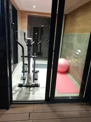 a view of a gym through a glass door at Penthouse Lux in Belgrade