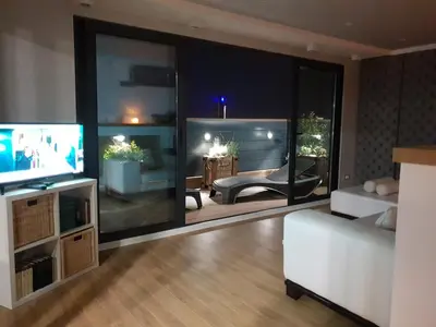 a living room with a television and a couch at Penthouse Lux in Belgrade