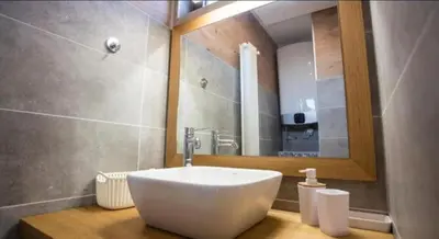 a bathroom with a sink and a mirror at Penthouse Lux in Belgrade