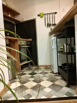 a kitchen with a black and white checkered floor at Alexandar in Belgrade
