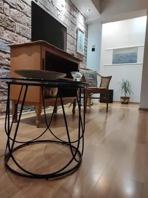a living room with a table and a piano at Alexandar in Belgrade