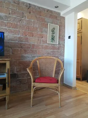 a chair in front of a brick wall at Alexandar in Belgrade