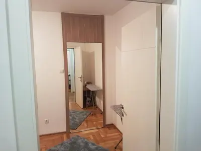 an empty room with a hallway with a mirror at Luka Lux apartman in Belgrade