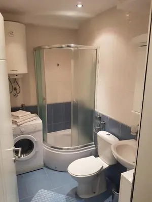 a bathroom with a shower and a toilet and a sink at Luka Lux apartman in Belgrade