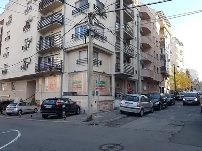 a street with cars parked in front of a building at Luka Lux apartman in Belgrade