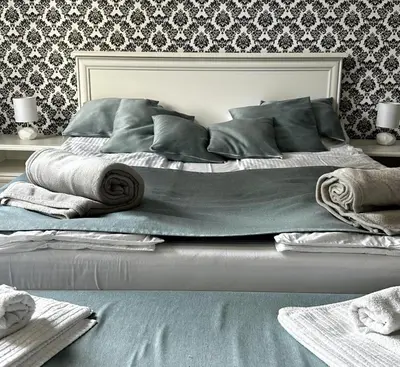 a bedroom with a large bed with blankets and pillows at Bloom apartments in Belgrade