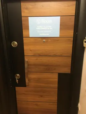 a wooden door with a sign on it at Bloom apartments in Belgrade