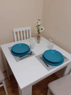 a white table with two blue plates on it at Apartment Marija in Belgrade