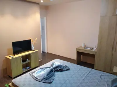 a bedroom with a bed and a tv on a cabinet at Alba Graeca in Belgrade
