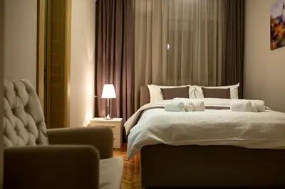 a bedroom with a bed with two stuffed animals on it at Vracar Vuk 1 in Belgrade