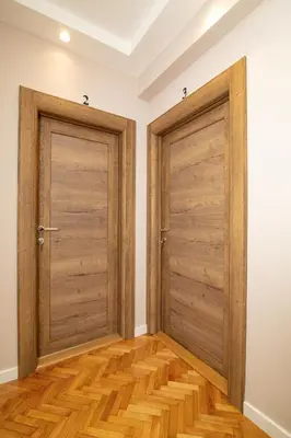 two wooden doors in a room with wood floors at Vracar Vuk 1 in Belgrade