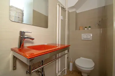 a bathroom with a red sink and a toilet at Vracar Vuk 1 in Belgrade