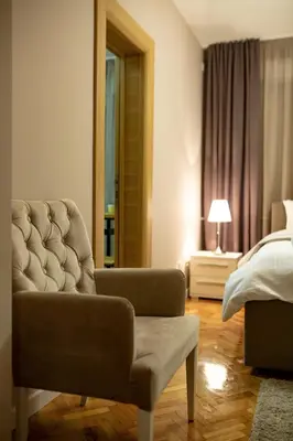 a bedroom with a couch and a bed and a chair at Vracar Vuk 1 in Belgrade
