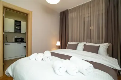 a hotel room with a bed with towels on it at Vracar Vuk 1 in Belgrade