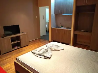 a room with a bed and a flat screen tv at Castel Bianco in Belgrade
