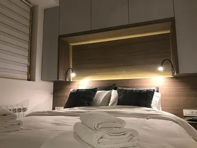 a bedroom with a large bed with towels on it at INNA Luxe & Wine- Central Belgrade Apartments in Belgrade