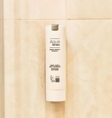 a white bottle of advuana glue sitting on a tile at INNA Luxe & Wine- Central Belgrade Apartments in Belgrade
