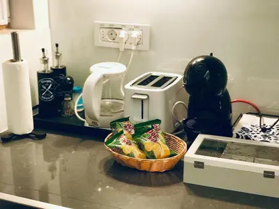 a kitchen counter with a basket of food and a toaster at INNA Luxe & Wine- Central Belgrade Apartments in Belgrade