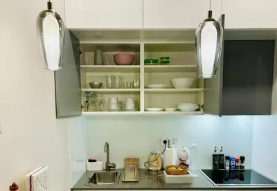 a kitchen with a counter with a sink and some lights at LIRRA LUXE - Central Belgrade Apartments in Belgrade