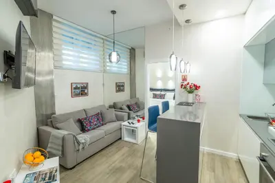 a living room with a couch and a table at LIRRA LUXE - Central Belgrade Apartments in Belgrade