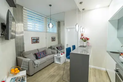 a living room with a couch and a table at LIRRA LUXE - Central Belgrade Apartments in Belgrade