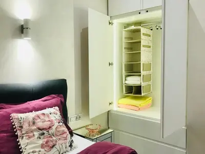 a bedroom with a bed and a mirror and towels at LIRRA LUXE - Central Belgrade Apartments in Belgrade