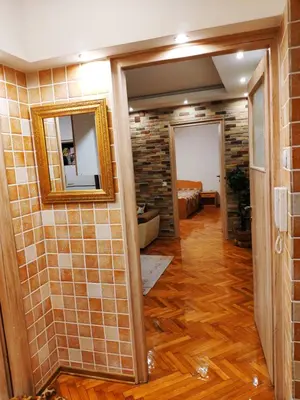 a room with a mirror and a tile wall at V2 with Love - Vintage Modern and Spacious in Belgrade
