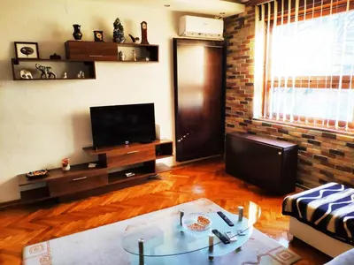 a living room with a couch and a table and a television at V2 with Love - Vintage Modern and Spacious in Belgrade
