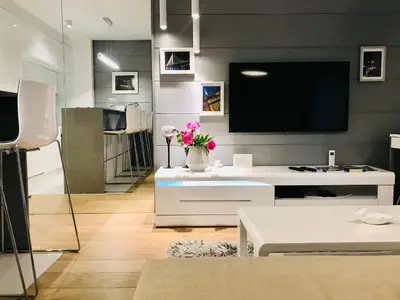 a living room with a flat screen tv on a wall at SLAVNA - Luxe & Wine by the Fortress in Belgrade