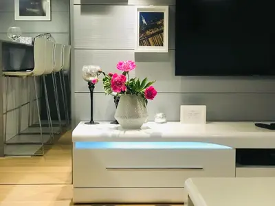 a vase with pink flowers on top of a table at SLAVNA - Luxe & Wine by the Fortress in Belgrade