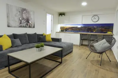 a living room with a couch and a table at St.Sava apartment in Belgrade