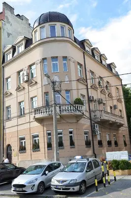 two cars parked in front of a building at St.Sava apartment in Belgrade