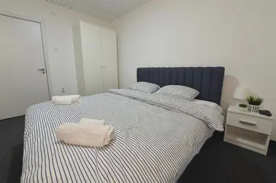 a bedroom with a large bed with two towels on it at St.Sava apartment in Belgrade