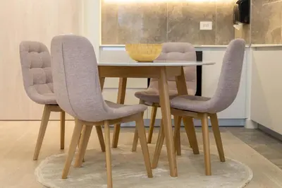 a dining room table with two chairs and a bowl on it at Apartments Royal - Belgrade Waterfront in Belgrade