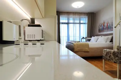 a hotel room with a bed and a couch at Apartments Royal - Belgrade Waterfront in Belgrade