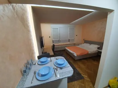 a room with a table with blue plates on it at Apartman DoDoLu in Belgrade
