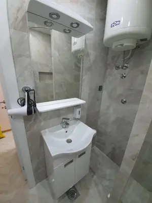 a bathroom with a white sink and a mirror at Apartman DoDoLu in Belgrade