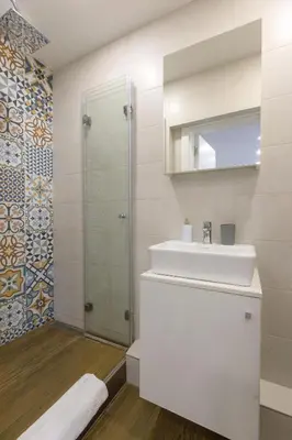 a white bathroom with a sink and a shower at Apartment Sovre in Belgrade