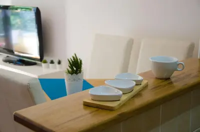 a wooden table with three bowls and a cup on it at Dunavski Kej in Smederevo