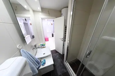 a bathroom with a shower and a sink at Apartment 