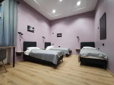 a room with three beds in a room at K43 Rooms in Belgrade