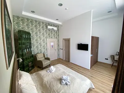 a bedroom with a bed with a teddy bear on it at K43 Rooms in Belgrade