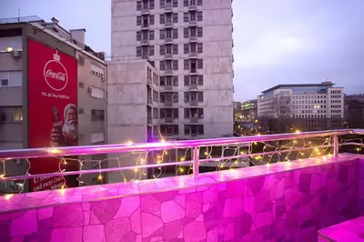 a bridge with pink lights on it in a city at Balkanic Star Belgrade in Belgrade