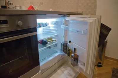 an empty refrigerator with its door open in a kitchen at Balkanic Star Belgrade in Belgrade