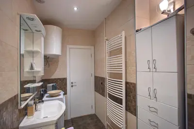 a small bathroom with a sink and a mirror at Balkanic Star Belgrade in Belgrade