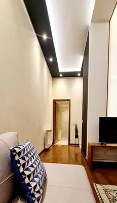 a living room with a couch and a ceiling at Lux apartment in city center in Belgrade
